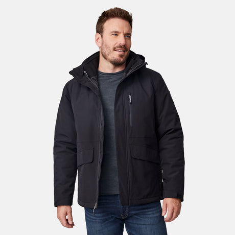 [Joe is 6’0” wearing size M.] Man wearing Free Country Men's Ski Patrol 3-in-1 Systems Jacket in black with a full front zipper opening, an outer jacket for wind and cold weather, an inner puffer jacket, and wind resistant and water resistant stretch performance fabric, light grey background. Perfect men’s jacket for winter weather.