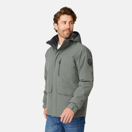 [Matt is 6’2” wearing size M.] Man wearing Free Country Men's Ski Patrol 3-in-1 Systems Jacket in grey with a full front zipper opening, an outer jacket for wind and cold weather, an inner puffer jacket, and wind resistant and water resistant stretch performance fabric, light grey background. Perfect men’s jacket for winter weather.