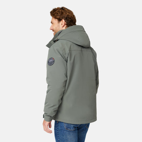 [Matt is 6’2” wearing size M.] Man wearing Free Country Men's Ski Patrol 3-in-1 Systems Jacket in grey with a full front zipper opening, an outer jacket for wind and cold weather, an inner puffer jacket, and wind resistant and water resistant stretch performance fabric, light grey background. Perfect men’s jacket for winter weather.
