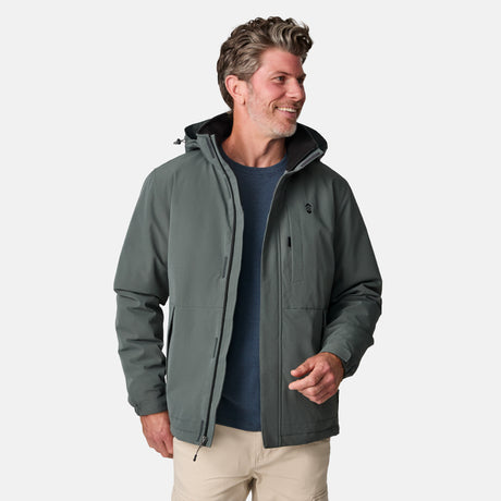 [Kolby is 6’2” wearing size M.]  "Men’s Free Country dark gray zip-front jacket with hood and chest pocket—layered over blue shirt and beige pants for a casual, transitional-weather look.