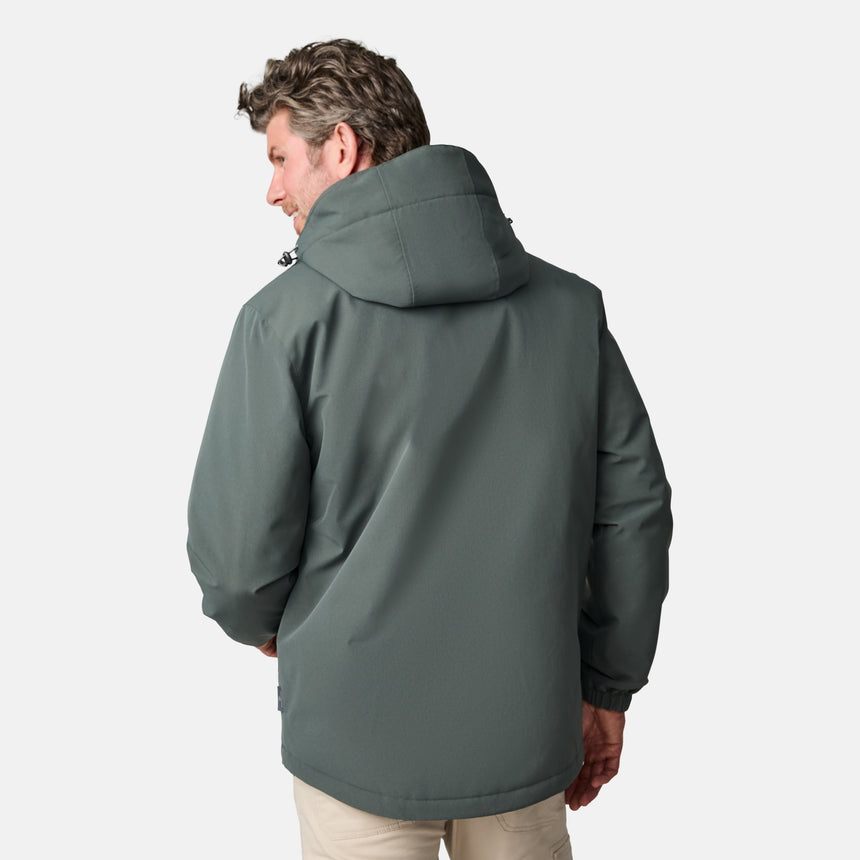 [Kolby is 6’2” wearing size M.]  "Men’s Free Country dark gray zip-front jacket with hood and chest pocket—layered over blue shirt and beige pants for a casual, transitional-weather look.