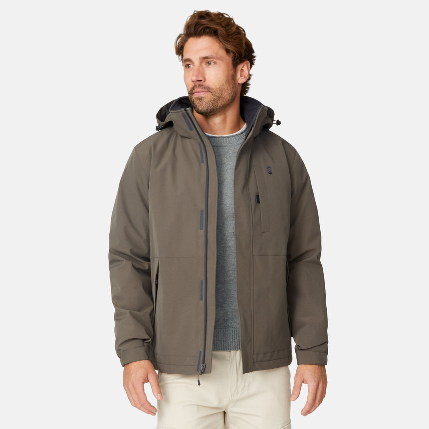 [Matt is 6'2" wearing size M.] Men’s Free Country brown zip-front hooded jacket with chest pocket and angled side pockets—layered over a gray crewneck shirt and beige pants for a casual, lightweight outdoor look.