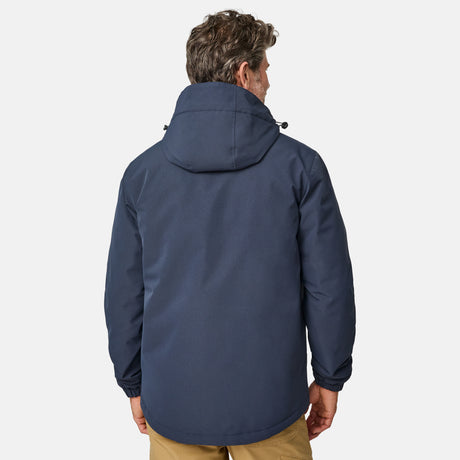 [Kolby is 6’2” wearing size M.] Men’s Free Country navy zip-front jacket with hood and high collar, featuring vertical chest zipper pocket and side hand pockets—worn over light brown pants for an outdoors-ready, insulated look.
