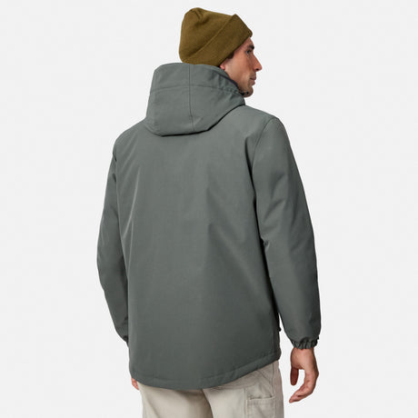 Back view of a man in a gray Denali insulated jacket with hood.