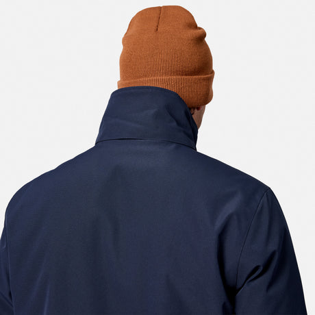 [Model is wearing size M.] Back view of a person wearing a navy blue jacket and an orange-brown knit beanie against a light gray background.