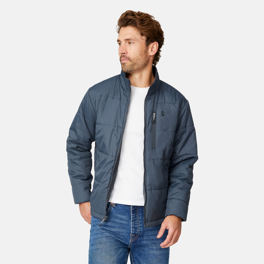 [Matt is 6’2” wearing size M.] Man wearing Free Country Men's Ski Patrol 3-in-1 Systems Jacket in grey with a full front zipper opening, an outer jacket for wind and cold weather, an inner puffer jacket, and wind resistant and water resistant stretch performance fabric, light grey background. Perfect men’s jacket for winter weather.