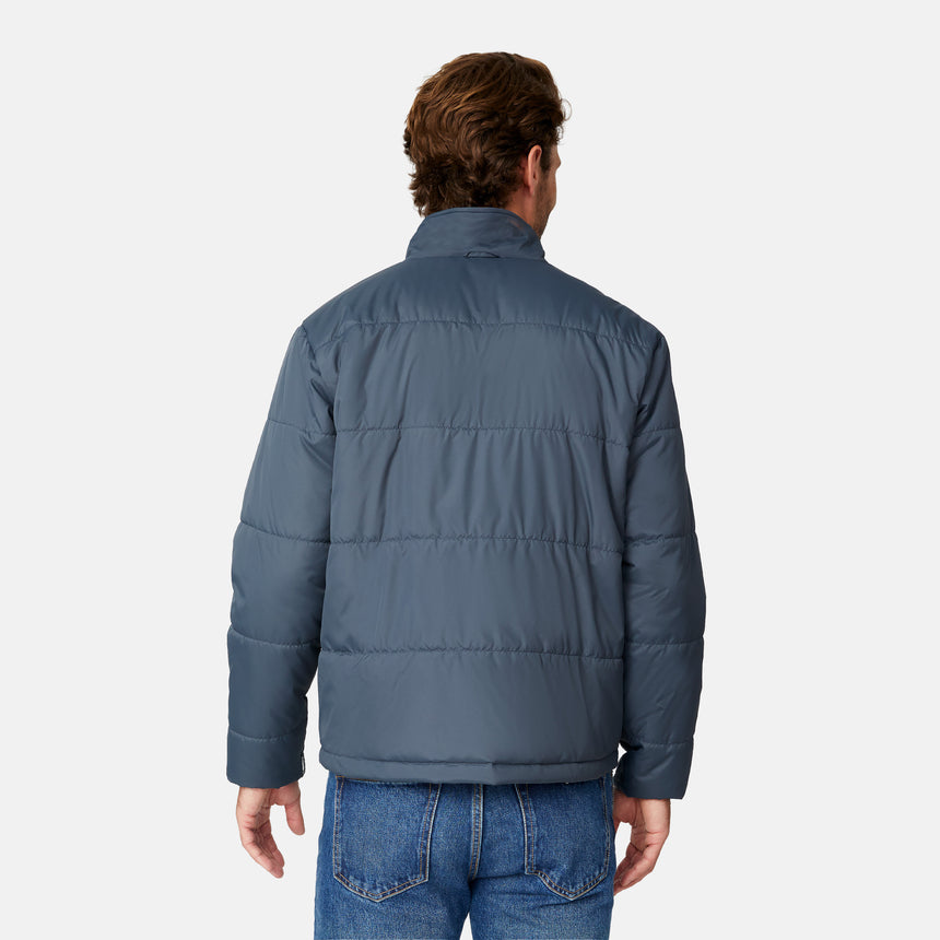 [Matt is 6’2” wearing size M.] Man wearing Free Country Men's Ski Patrol 3-in-1 Systems Jacket in grey with a full front zipper opening, an outer jacket for wind and cold weather, an inner puffer jacket, and wind resistant and water resistant stretch performance fabric, light grey background. Perfect men’s jacket for winter weather.