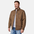 [Joe is 6'0" wearing size M.] Men’s Free Country brown canvas jacket layered over a white crewneck tee and blue jeans—features zippered chest pockets and left-side logo patch for rugged outdoor appeal and everyday versatility.