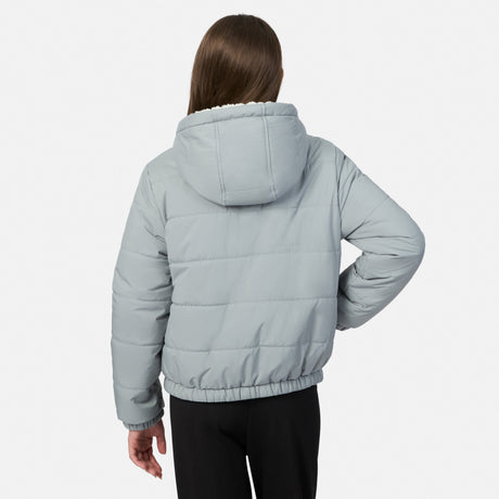 A child model shown from the back wearing a light gray hooded puffer jacket with black pants, photographed against a clean light gray studio background.