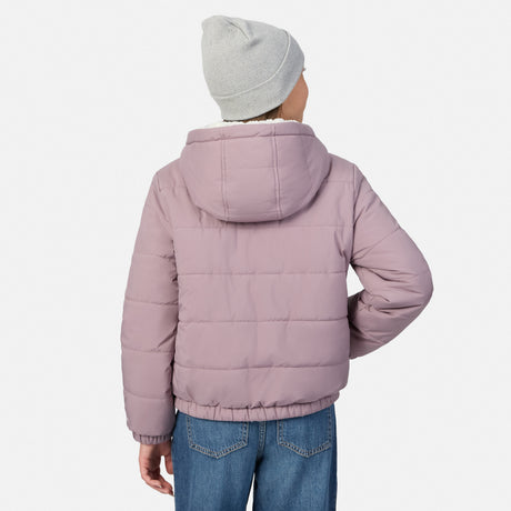 A child shown from the back wearing a light pink hooded puffer jacket, blue jeans, and a light gray beanie against a plain white background.