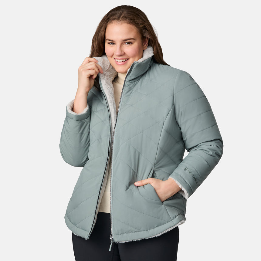 [Karissa is 5'9.5" wearing size 1X.] Woman wearing a sage green quilted reversible Free Country jacket on a white background