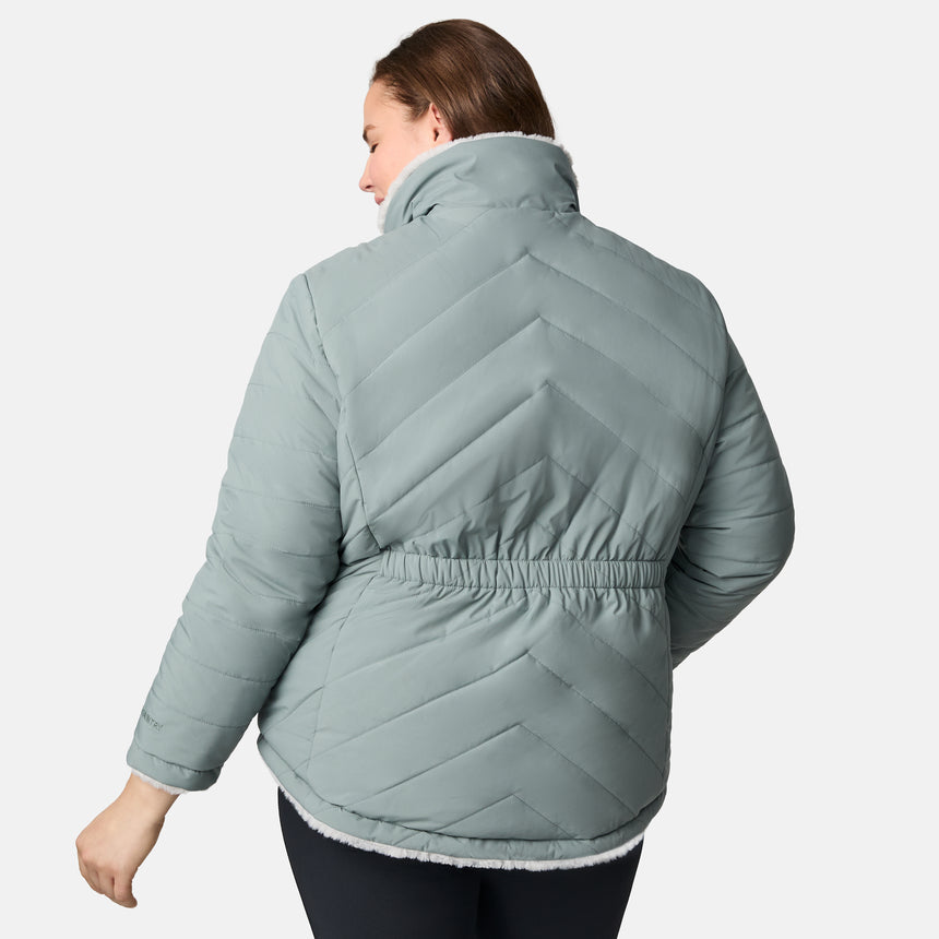 [Karissa is 5'9.5" wearing size 1X.] Woman wearing a sage green quilted reversible Free Country jacket on a white background