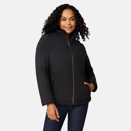 [Angelique is 5'10" wearing size S.] Woman wearing a black quilted reversible Free Country jacket on a white background