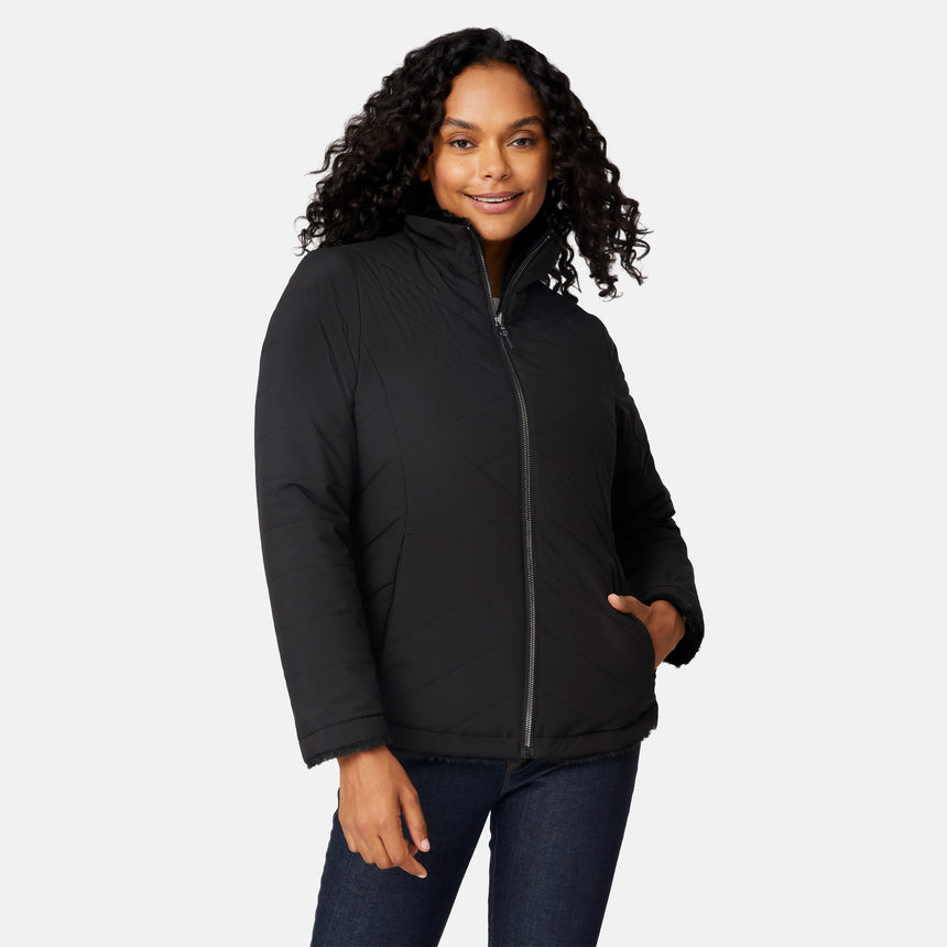[Angelique is 5'10" wearing size S.] Woman wearing a black quilted reversible Free Country jacket on a white background