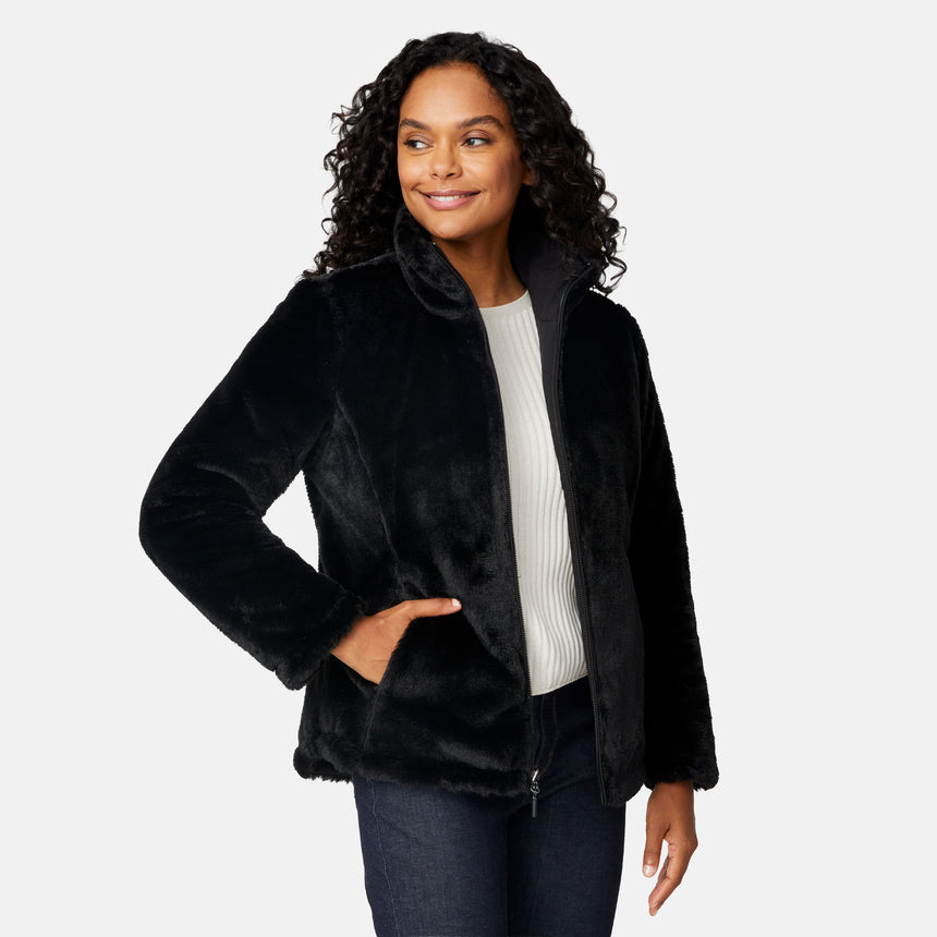 [Angelique is 5'10" wearing size S.] Woman wearing a black quilted reversible Free Country jacket on a white background