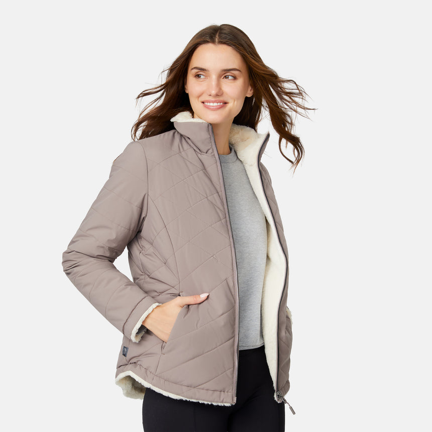 [Jessica is 5'9.5" wearing size S.] Woman wearing a brown quilted reversible Free Country jacket on a white background