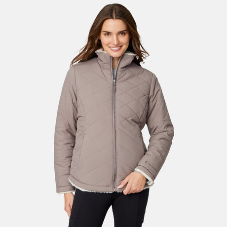 [Jessica is 5'9.5" wearing size S.] Woman wearing a brown quilted reversible Free Country jacket on a white background