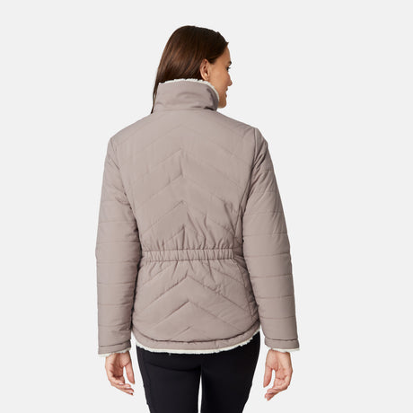 [Jessica is 5'9.5" wearing size S.] Woman wearing a brown quilted reversible Free Country jacket on a white background
