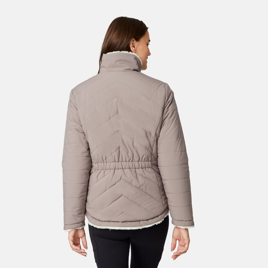 [Jessica is 5'9.5" wearing size S.] Woman wearing a brown quilted reversible Free Country jacket on a white background