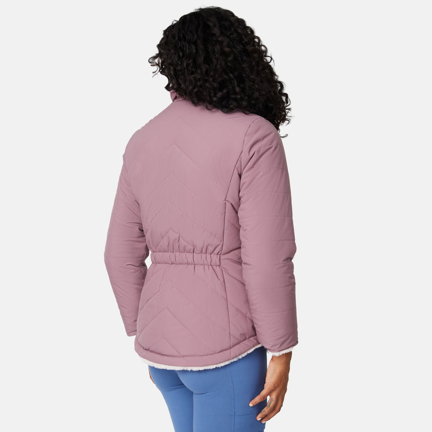 [Angelique is 5'10" wearing size S.] Woman wearing a pink quilted reversible Free Country jacket on a white background