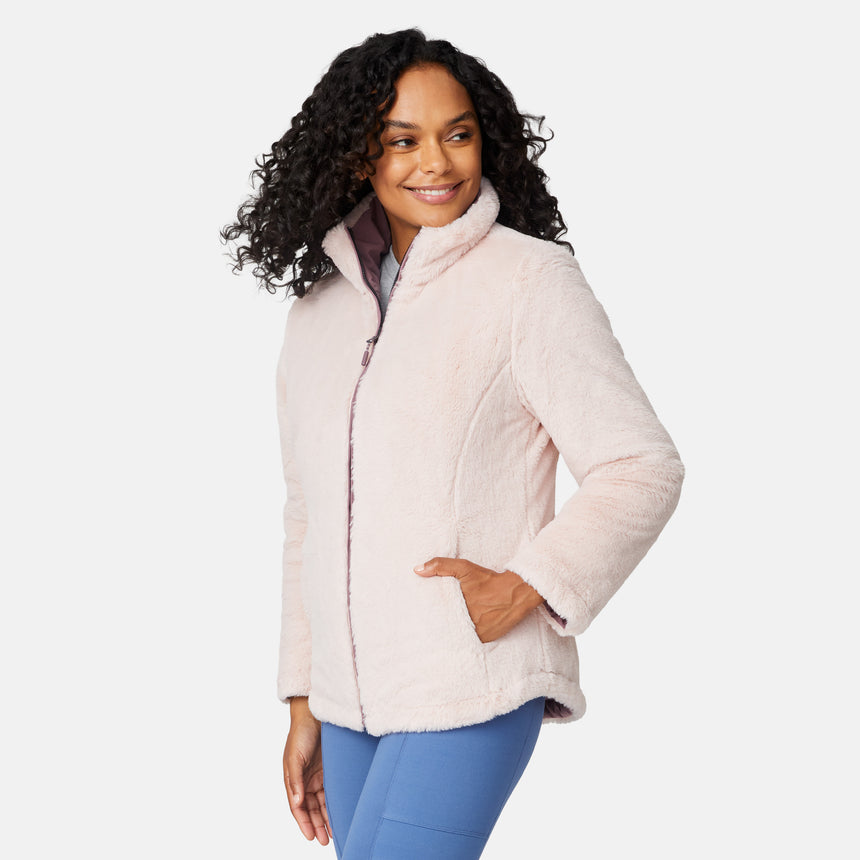 [Angelique is 5'10" wearing size S.] Woman wearing a pink quilted reversible Free Country jacket on a white background