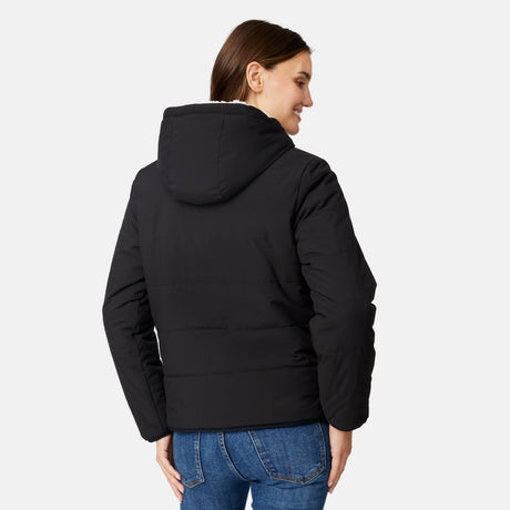 [Jessica is 5'9.5" wearing size S.] Free Country women’s black reversible quilted jacket with hood and patterned drawstrings, featuring zip-front closure and dual side pockets—styled with blue jeans for versatile, cold-weather wear.
