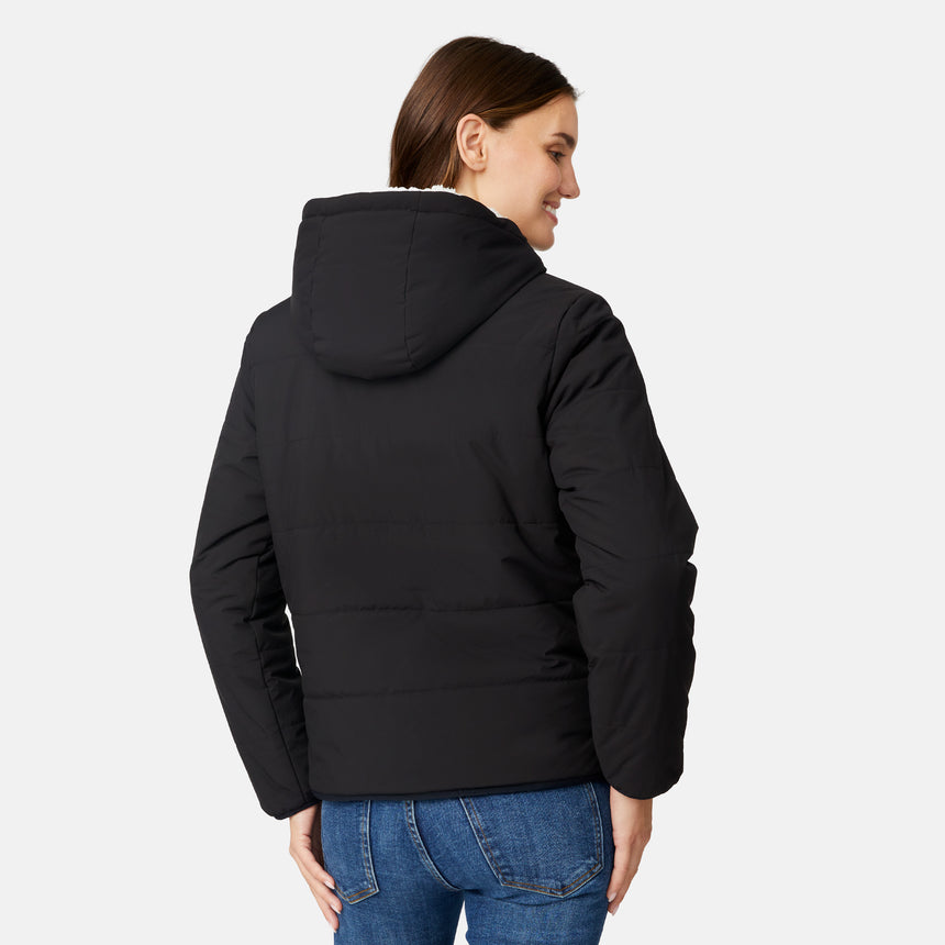 [Jessica is 5'9.5" wearing size S.] Free Country women’s black reversible quilted jacket with hood and patterned drawstrings, featuring zip-front closure and dual side pockets—styled with blue jeans for versatile, cold-weather wear.