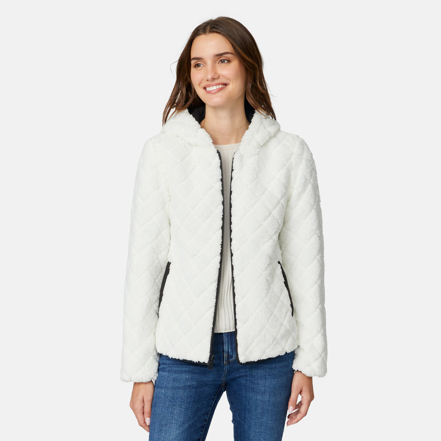 [Jessica is 5'9.5" wearing size S.] Free Country women’s black reversible quilted jacket with hood and patterned drawstrings, featuring zip-front closure and dual side pockets—styled with blue jeans for versatile, cold-weather wear.