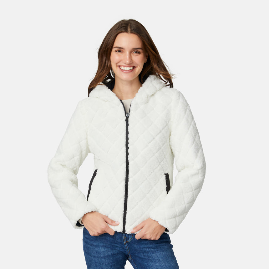 [Jessica is 5'9.5" wearing size S.] Free Country women’s black reversible quilted jacket with hood and patterned drawstrings, featuring zip-front closure and dual side pockets—styled with blue jeans for versatile, cold-weather wear.