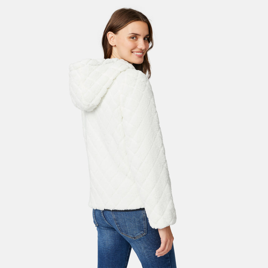 [Jessica is 5'9.5" wearing size S.] Free Country women’s black reversible quilted jacket with hood and patterned drawstrings, featuring zip-front closure and dual side pockets—styled with blue jeans for versatile, cold-weather wear.