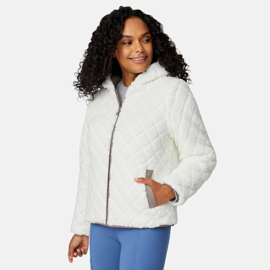 [Angelique is 5'10" wearing size S.] Light brown quilted reversible jacket with fleece-lined hood, zip front, and pockets; worn over grey shirt and blue pants.