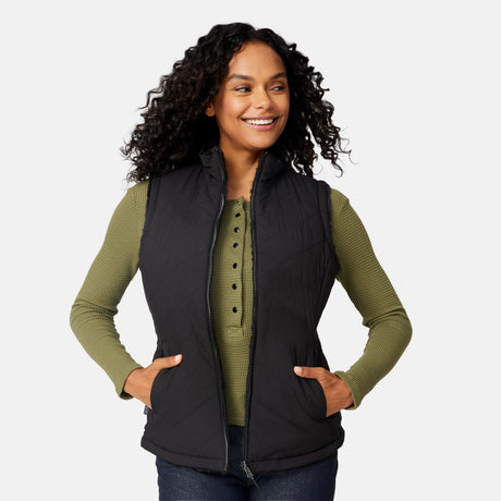 [Angelique is 5'10" wearing size S.] Woman wearing a black vest over a green shirt on a white background