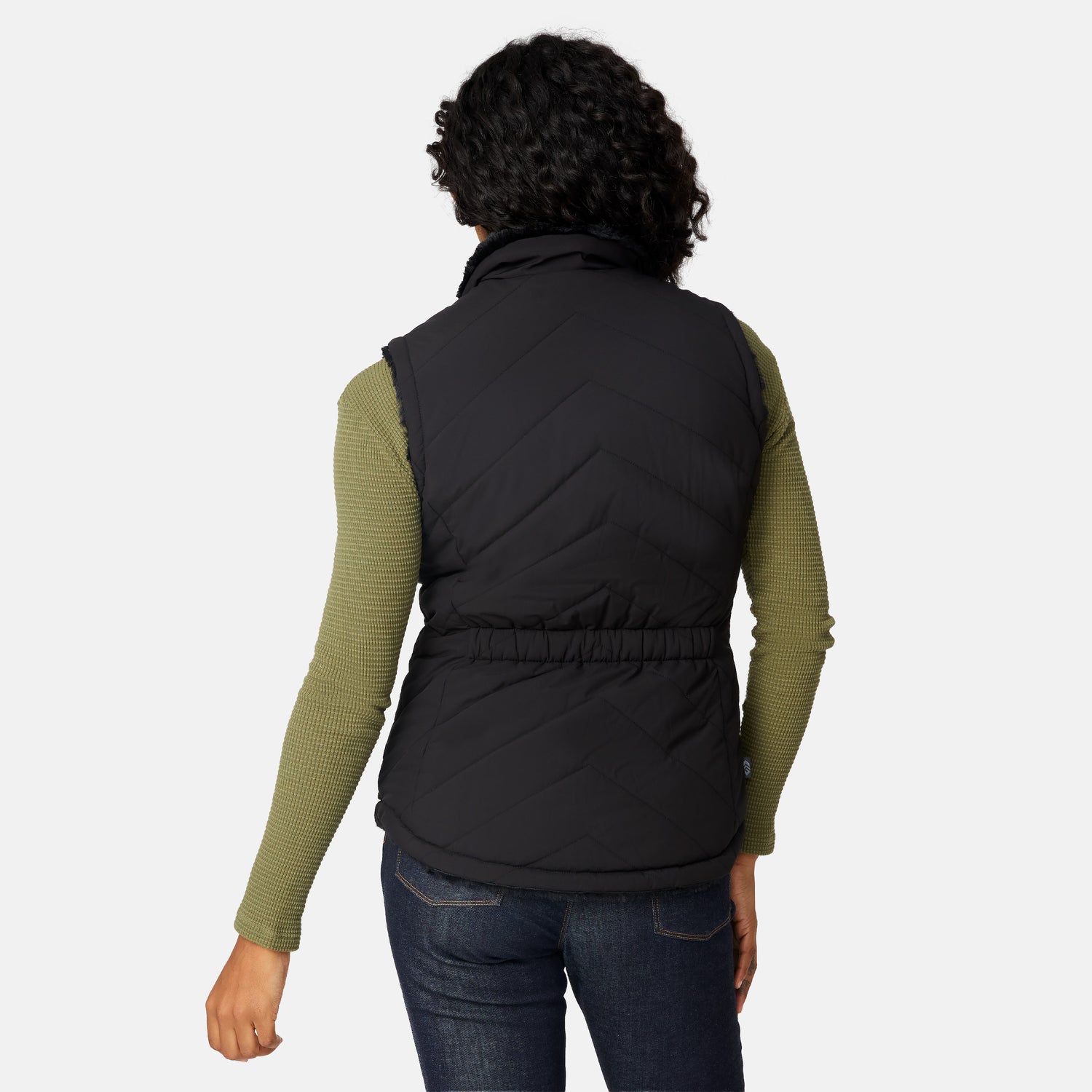 [Angelique is 5'10" wearing size S.] Person wearing a black puffer vest over a green long-sleeve shirt on a white background