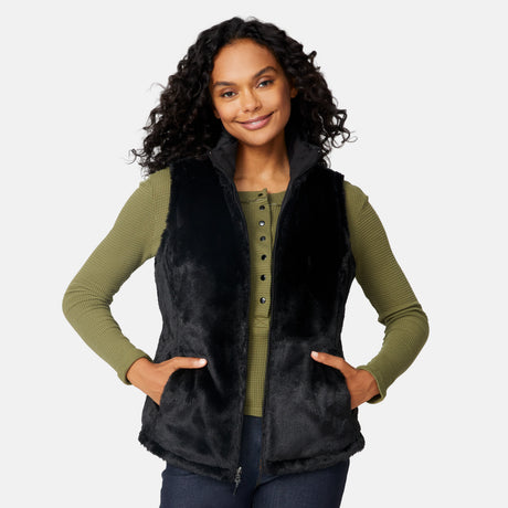 [Angelique is 5'10" wearing size S.] Woman wearing a black vest over a green long-sleeve shirt on a white background