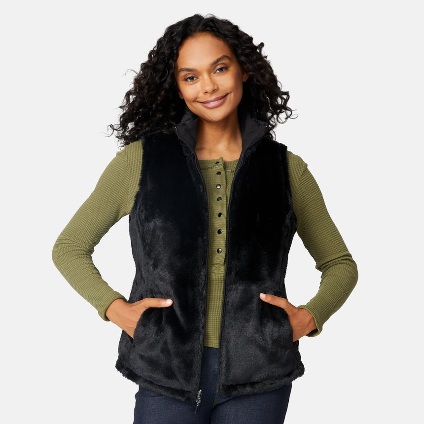 [Angelique is 5'10" wearing size S.] Woman wearing a black vest over a green long-sleeve shirt on a white background