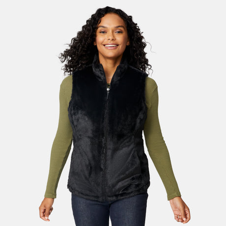 [Angelique is 5'10" wearing size S.] Woman wearing a black vest over a green long-sleeve shirt on a white background