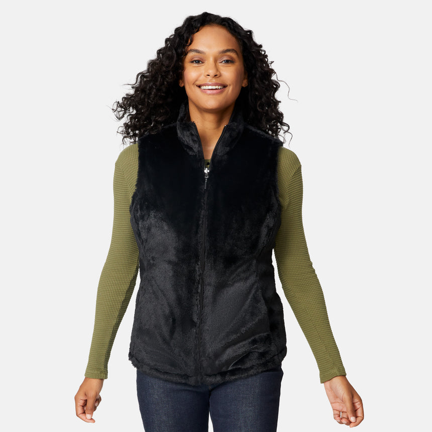 [Angelique is 5'10" wearing size S.] Woman wearing a black vest over a green long-sleeve shirt on a white background