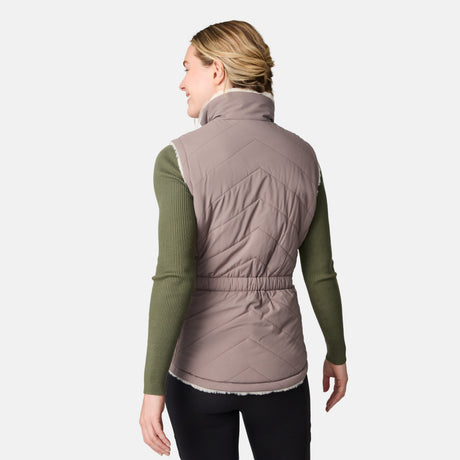 [CJ is 5'10" wearing size S.] Woman wearing a quilted vest over a green long-sleeve shirt on a white background