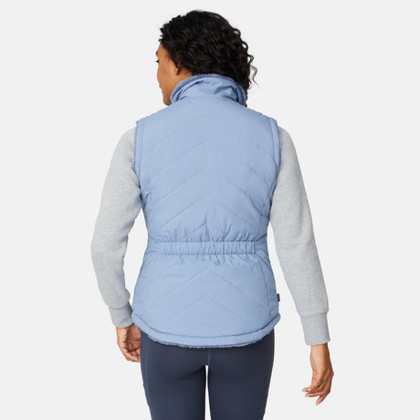 [Angelique is 5'10" wearing size S.] Person wearing a light blue puffer vest over a gray long-sleeve shirt on a white background