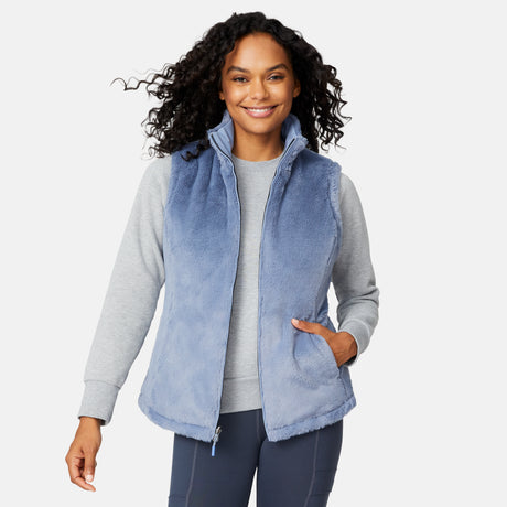 [Angelique is 5'10" wearing size S.] Woman wearing a blue fleece vest over a gray long-sleeve shirt on a white background