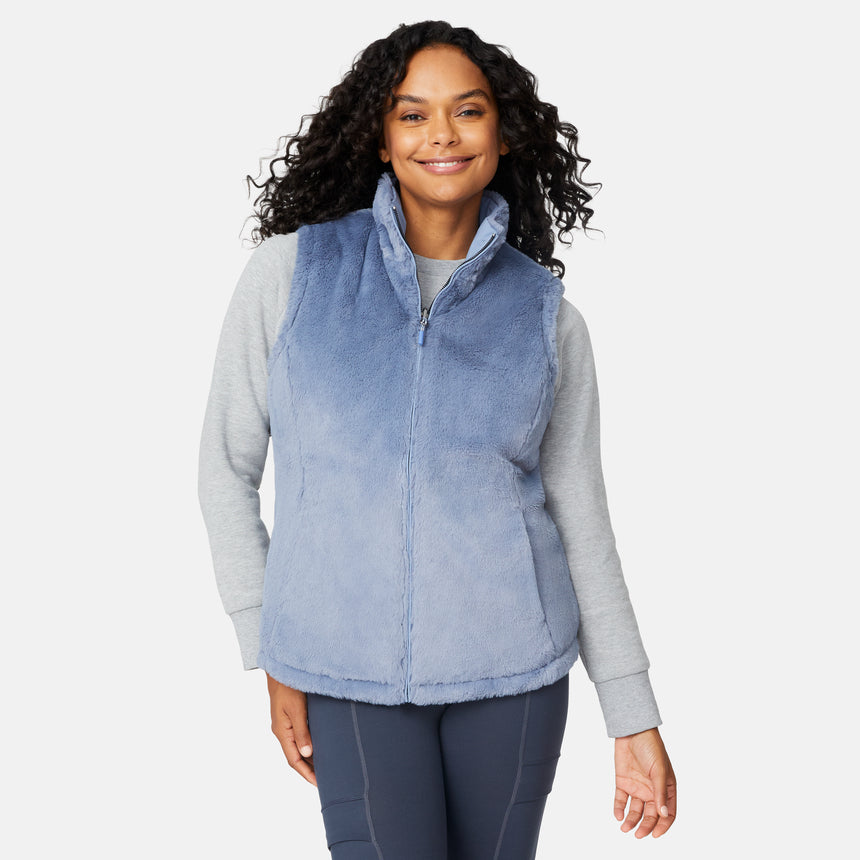 [Angelique is 5'10" wearing size S.] Woman wearing a blue fleece vest over a gray long-sleeve shirt on a white background