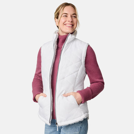 [CJ is 5'10" wearing size S.] Woman wearing a white quilted vest over a pink long-sleeve shirt on a white background