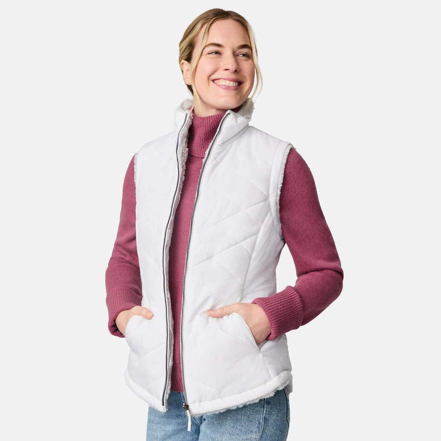 [CJ is 5'10" wearing size S.] Woman wearing a white quilted vest over a pink long-sleeve shirt on a white background
