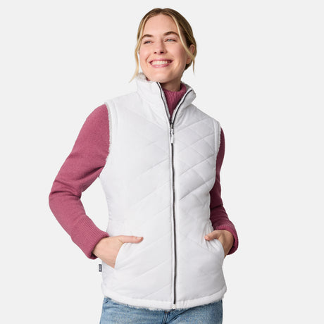 [CJ is 5'10" wearing size S.] Woman wearing a white quilted vest over a pink long-sleeve shirt on a white background