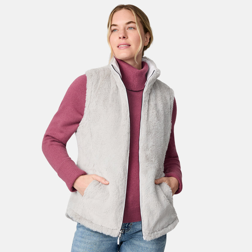[CJ is 5'10" wearing size S.] Woman wearing a white quilted vest over a pink long-sleeve shirt on a white background