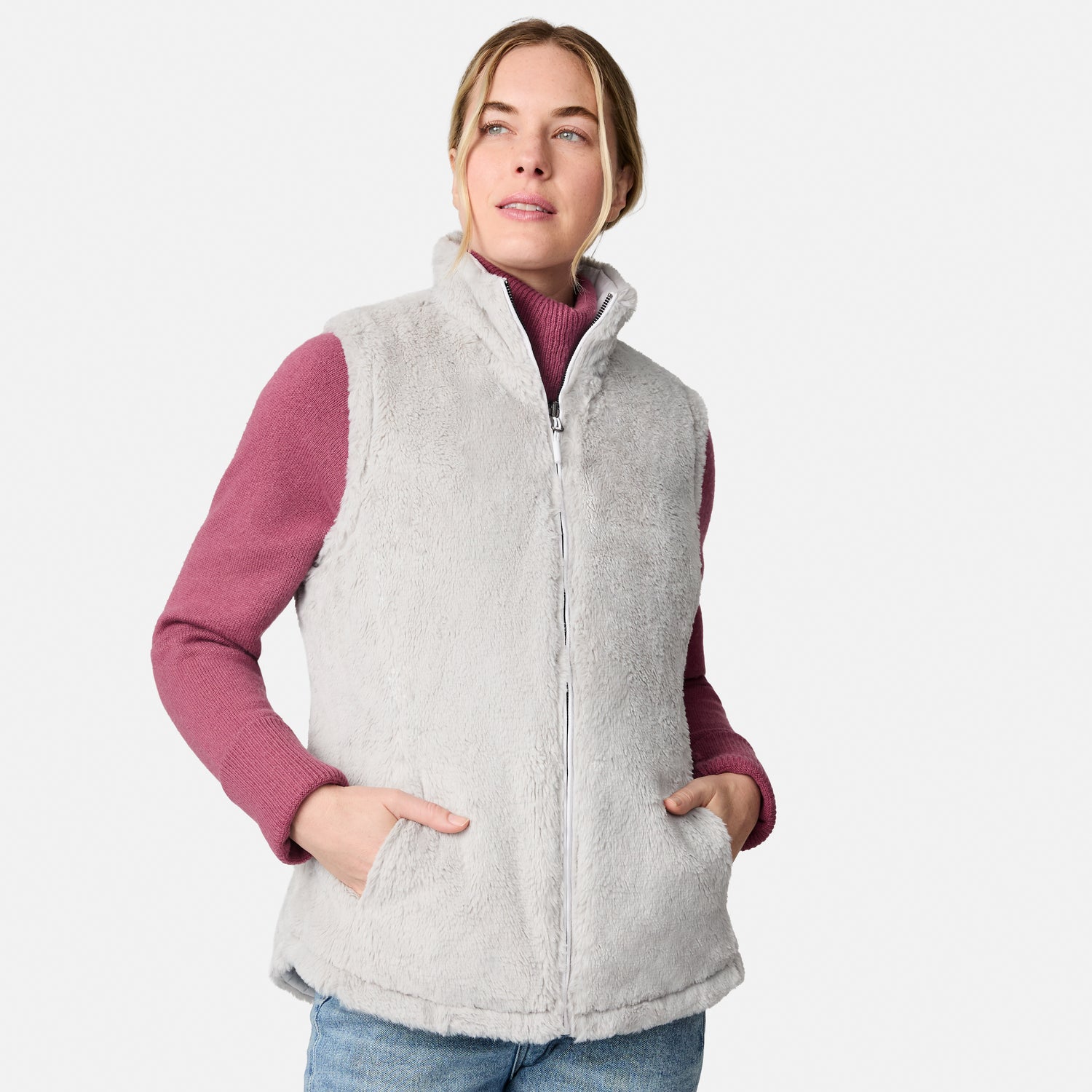 [CJ is 5'10" wearing size S.] Woman wearing a light gray vest over a pink long-sleeve shirt on a white background