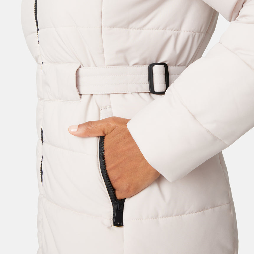 [Angelique is 5'10" wearing size S.] Close-up of a person wearing a white puffer coat with a belt and black zipper details.
