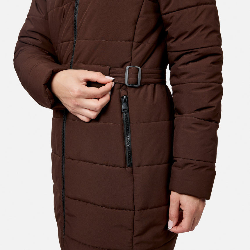 Free Country Women’s Cirrus Quilted Long Puffer Jacket in brown, featuring a belted waist, zippered pocket, and REPREVE insulation.
