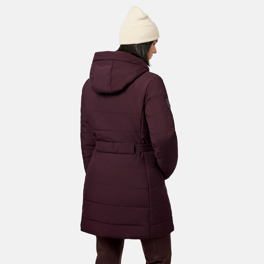 Back view of a person wearing a deep burgundy Free Country Women’s Cirrus Quilted Long Puffer Jacket with REPREVE insulation and a cream-colored beanie.