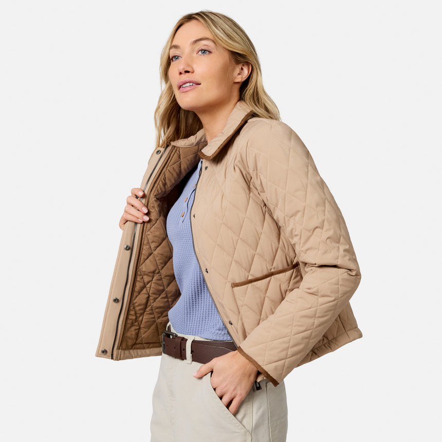 [Model is wearing size S.] A woman modeling a light tan diamond-quilted jacket with a brown lining, worn open over a light blue knit top and beige trousers, against a plain light gray background.